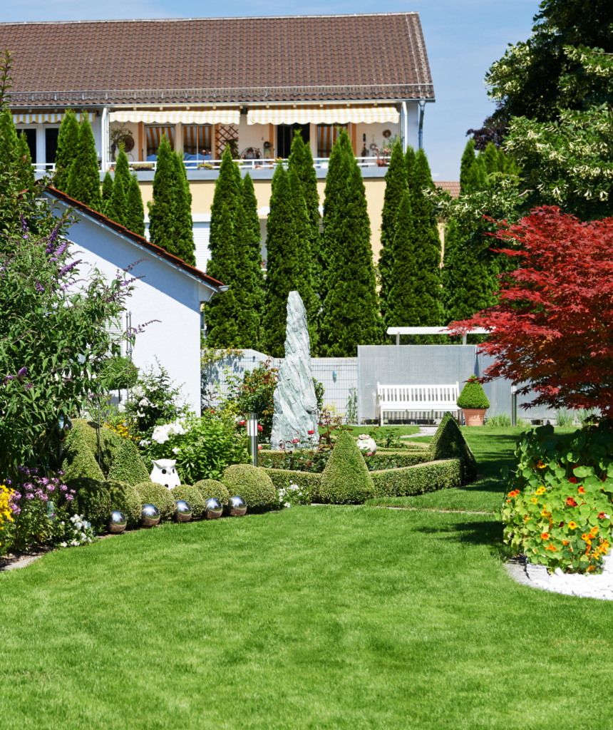 Well-Maintained Garden with Lush Greenery and Decorative Elements